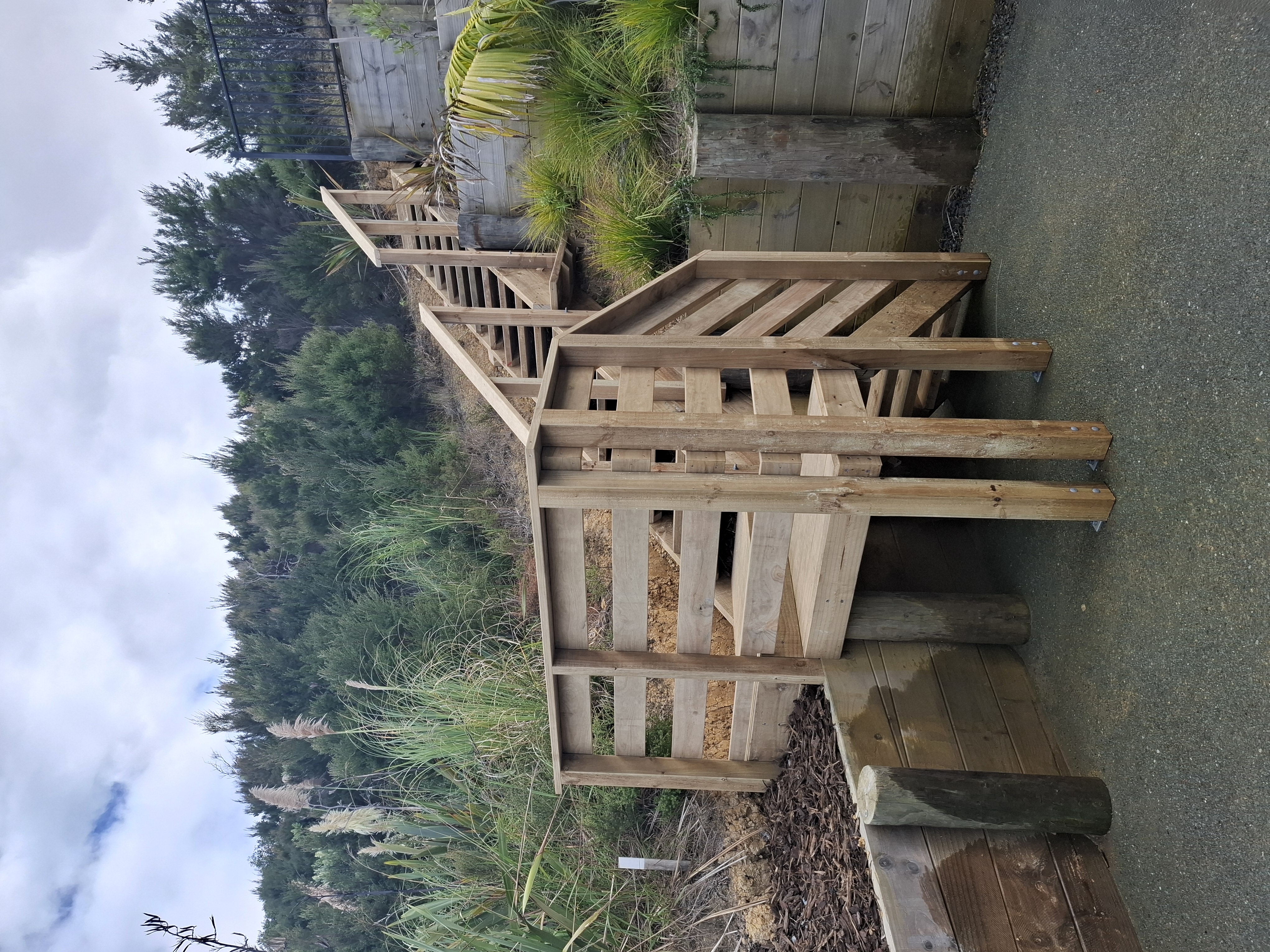Designed and built by our team, this custom outdoor stairway provides safe, practical access through the client's tiered gardens. Despite the steep terrain and challenging site access, the project was completed with precision to create a durable and attractive solution. - After