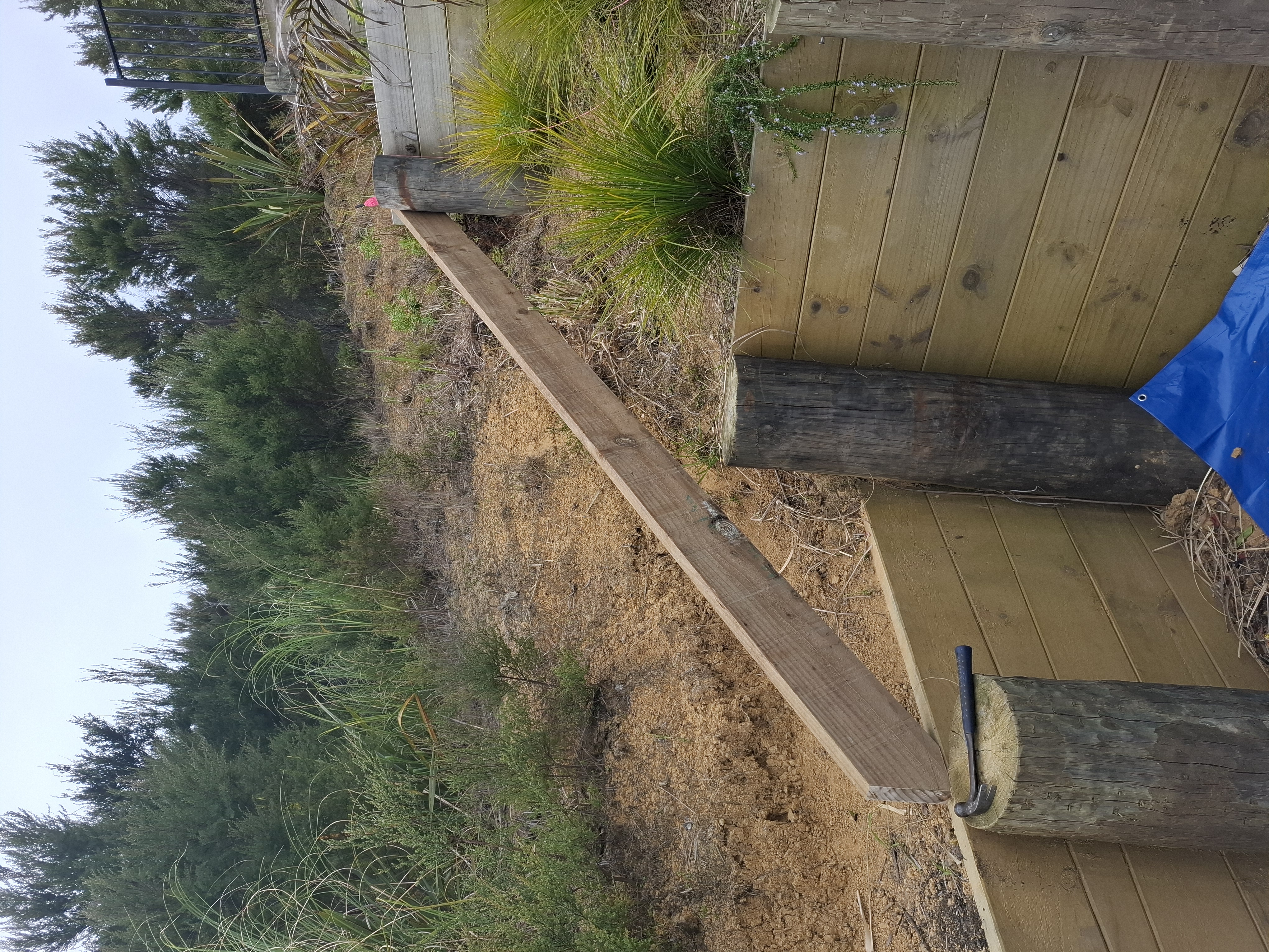Designed and built by our team, this custom outdoor stairway provides safe, practical access through the client's tiered gardens. Despite the steep terrain and challenging site access, the project was completed with precision to create a durable and attractive solution. - Before