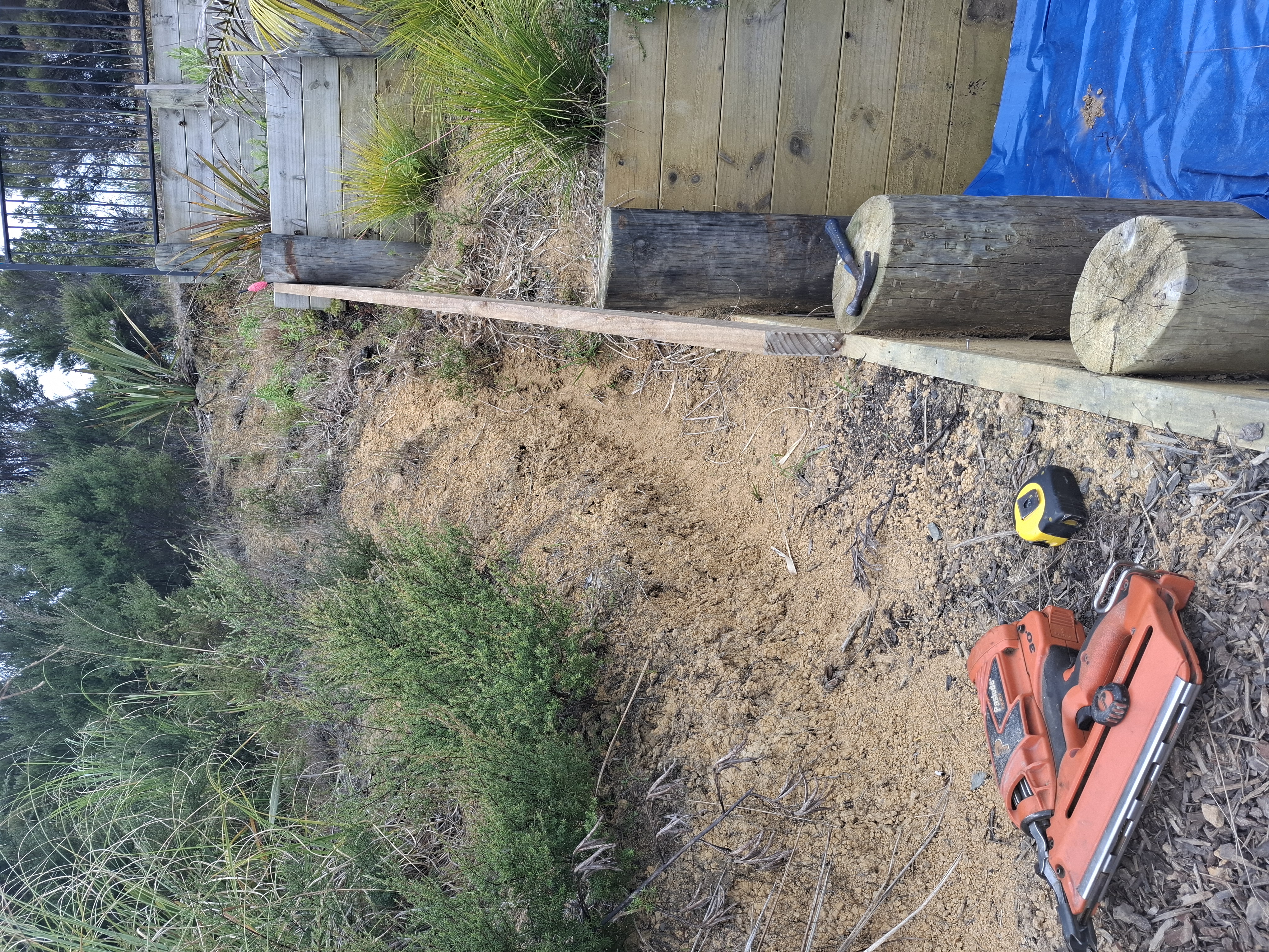 Designed and built by our team, this custom outdoor stairway provides safe, practical access through the client's tiered gardens. Despite the steep terrain and challenging site access, the project was completed with precision to create a durable and attractive solution. - Before