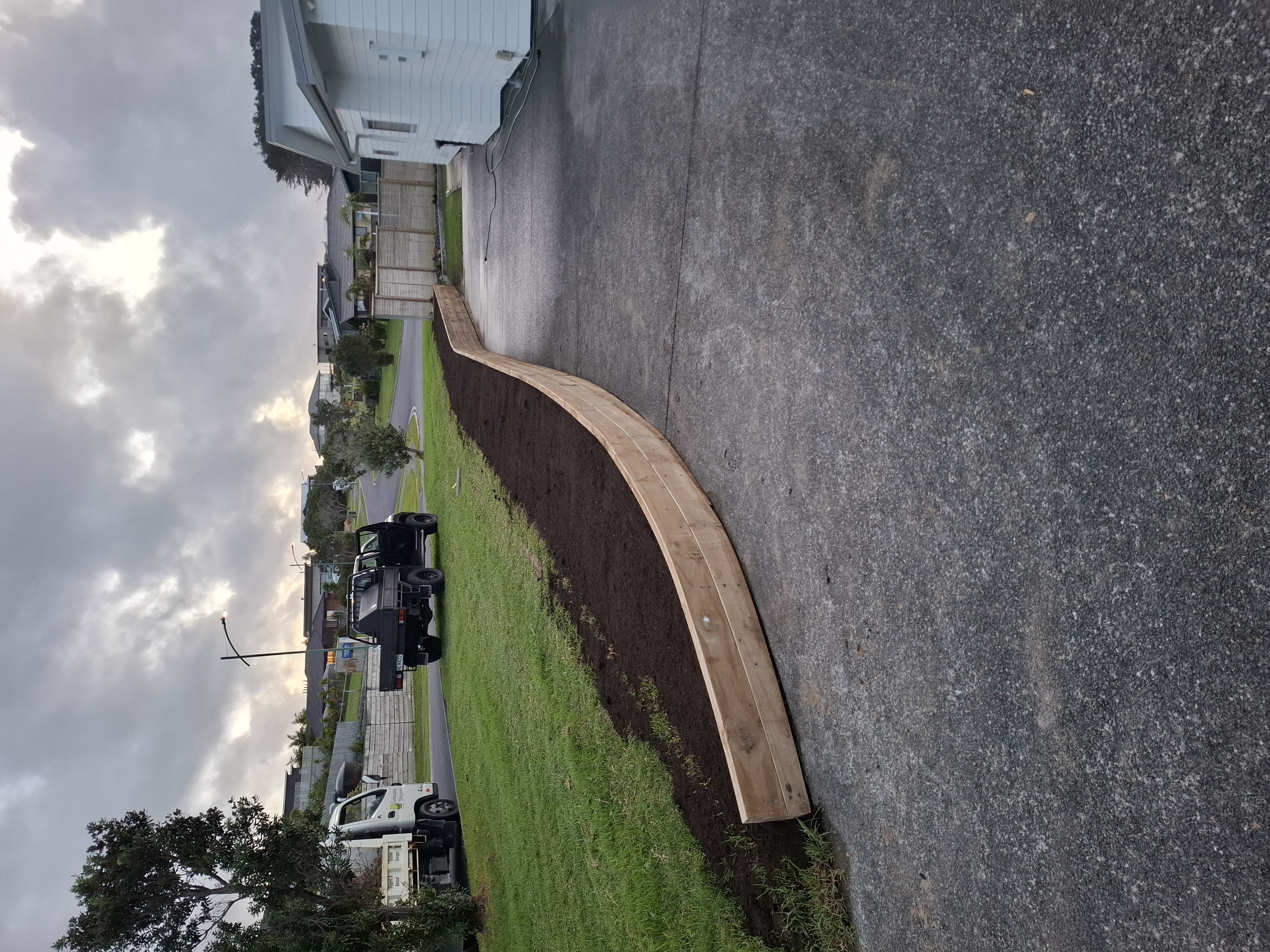 Designed and built by our team, this curved retaining wall was carefully constructed to follow the sweeping line of the driveway. While the curved design presented a unique challenge, the end result is a striking feature that blends seamlessly with the landscape. - After