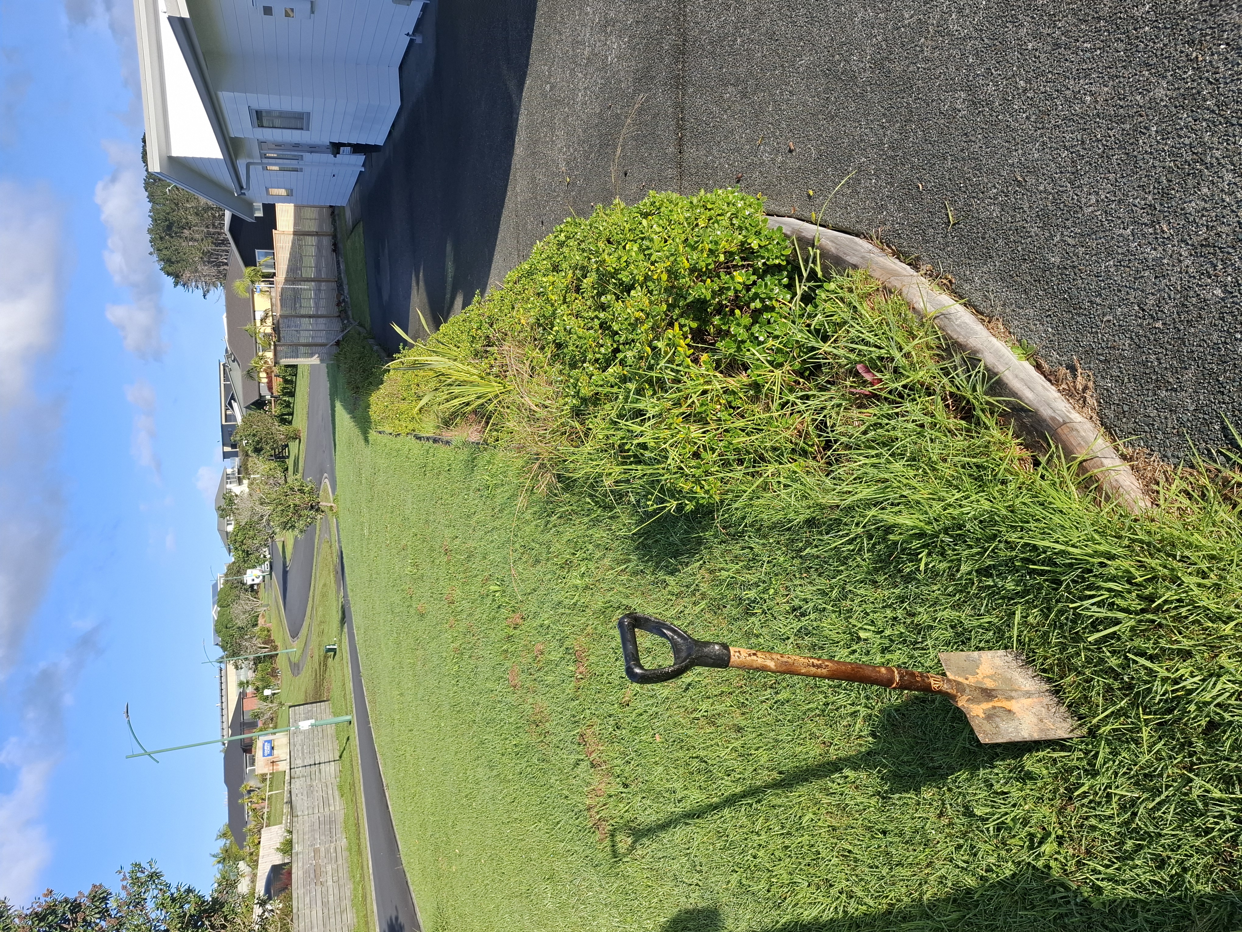 Designed and built by our team, this curved retaining wall was carefully constructed to follow the sweeping line of the driveway. While the curved design presented a unique challenge, the end result is a striking feature that blends seamlessly with the landscape. - Before
