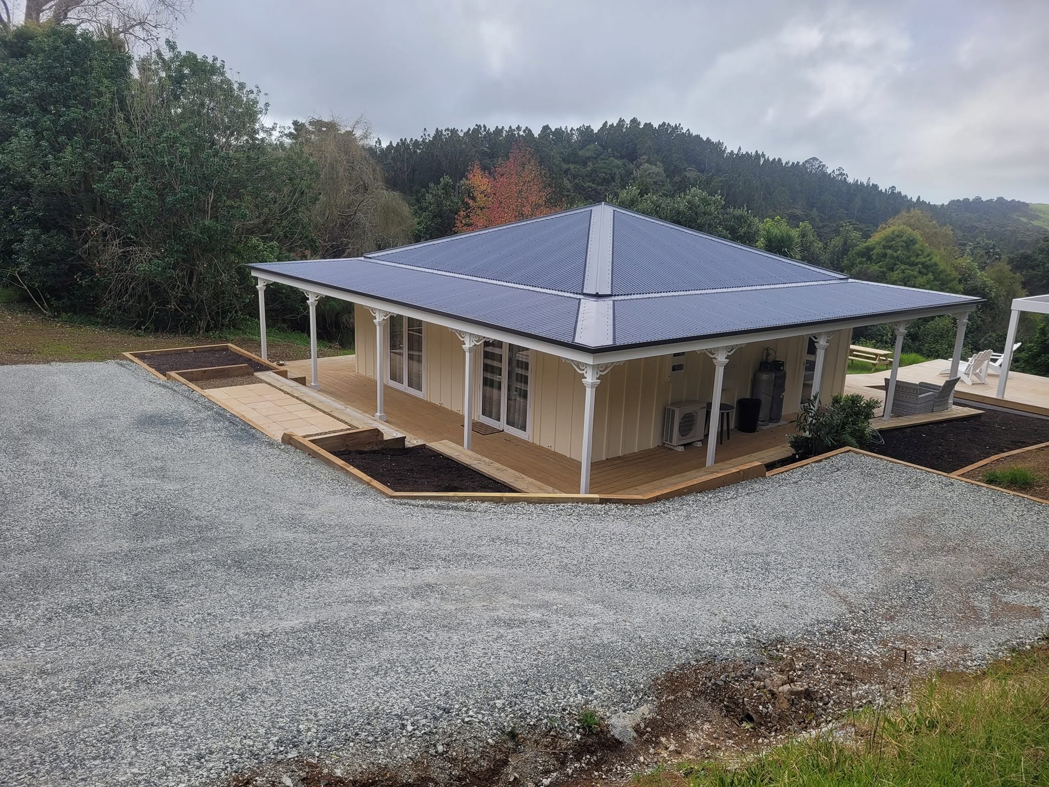 This complete landscape transformation was designed and built by our team, including site shaping, retaining walls, paved areas, driveway reformation, and extensive underground drainage. The result is a functional, durable, and well-finished outdoor space built to stand the test of time. - After