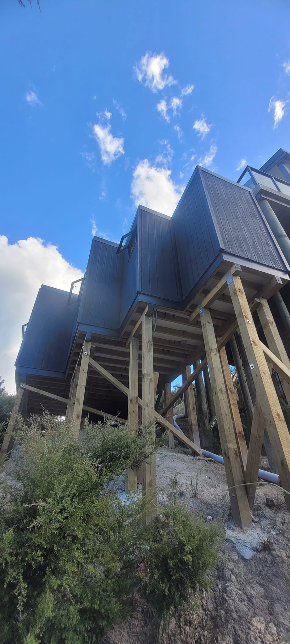 Built on an extremely challenging site, our team designed and constructed this custom standalone sleepout to seamlessly match the style and character of the client's home. - After